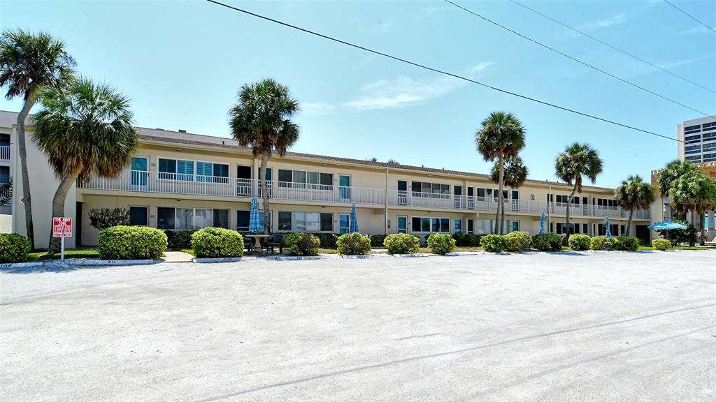 5950 Midnight Pass Road, Unit 201 Sarasota, FL 34242 - Photo 21 of 36 a view of a building with a yard