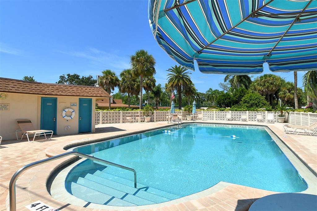 5950 Midnight Pass Road, Unit 201 Sarasota, FL 34242 - Photo 29 of 36 a swimming pool with outdoor seating and yard