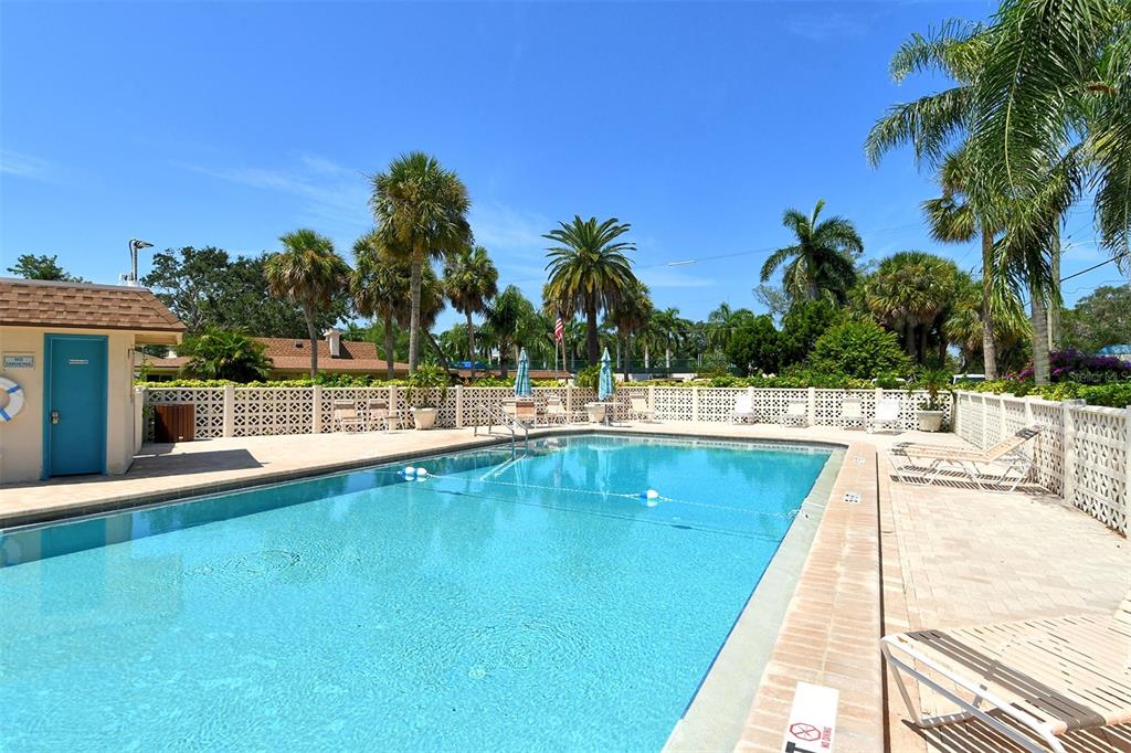 5950 Midnight Pass Road, Unit 201 Sarasota, FL 34242 - Photo 30 of 36 a view of swimming pool with outdoor seating and house in the background