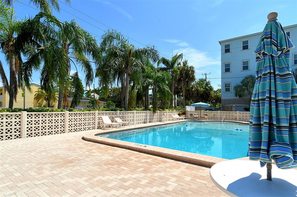 5950 Midnight Pass Road, Unit 201 Sarasota, FL 34242 - Photo 31 of 36 a view of a swimming pool with a patio