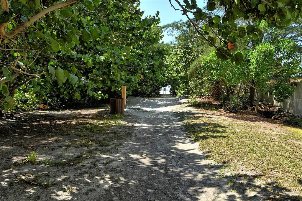 5950 Midnight Pass Road, Unit 201 Sarasota, FL 34242 - Photo 33 of 36 a backyard of a house with lots of green space