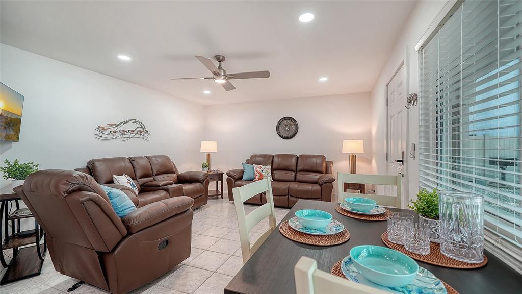 5950 Midnight Pass Road, Unit 201 Sarasota, FL 34242 - Photo 4 of 36 a living room with furniture and a potted plant