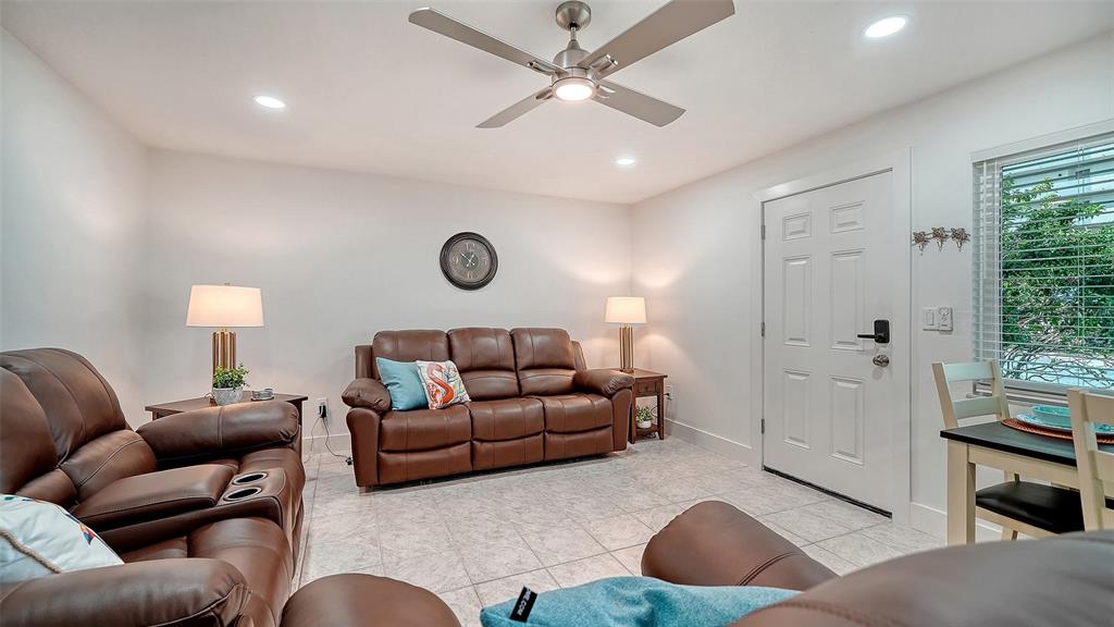 5950 Midnight Pass Road, Unit 201 Sarasota, FL 34242 - Photo 5 of 36 a living room with furniture and a window