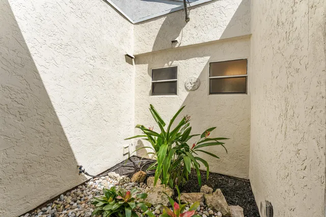 a vase of flowers sitting on a floor