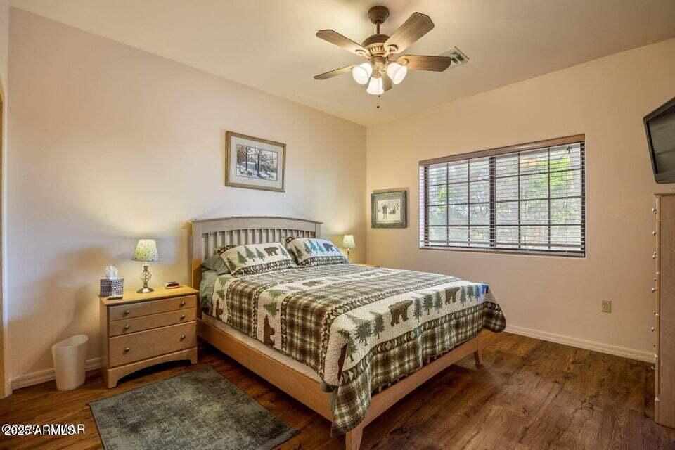 2522 Village Loop Pinetop, AZ 85935 - Photo 20 of 38 a bedroom with a bed chandelier and a window