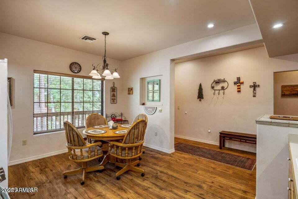 2522 Village Loop Pinetop, AZ 85935 - Photo 8 of 38 a dining room with furniture a chandelier and wooden floor