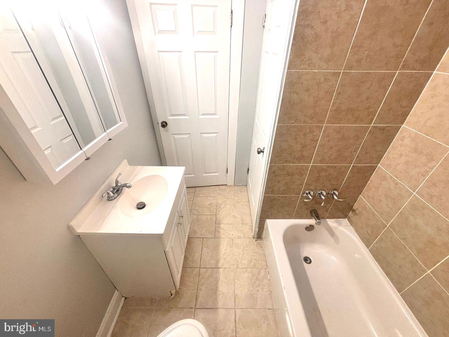 1736 North 59th Street Philadelphia, PA 19151 - Photo 14 of 19 a bathroom with a sink a toilet and shower