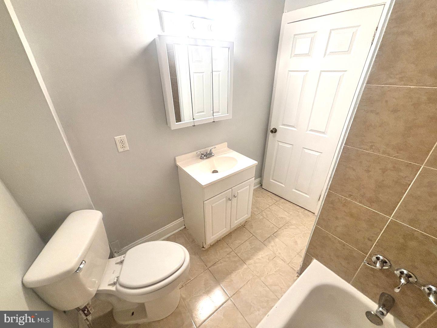 1736 North 59th Street Philadelphia, PA 19151 - Photo 15 of 19 a white toilet sitting next to a bathroom sink