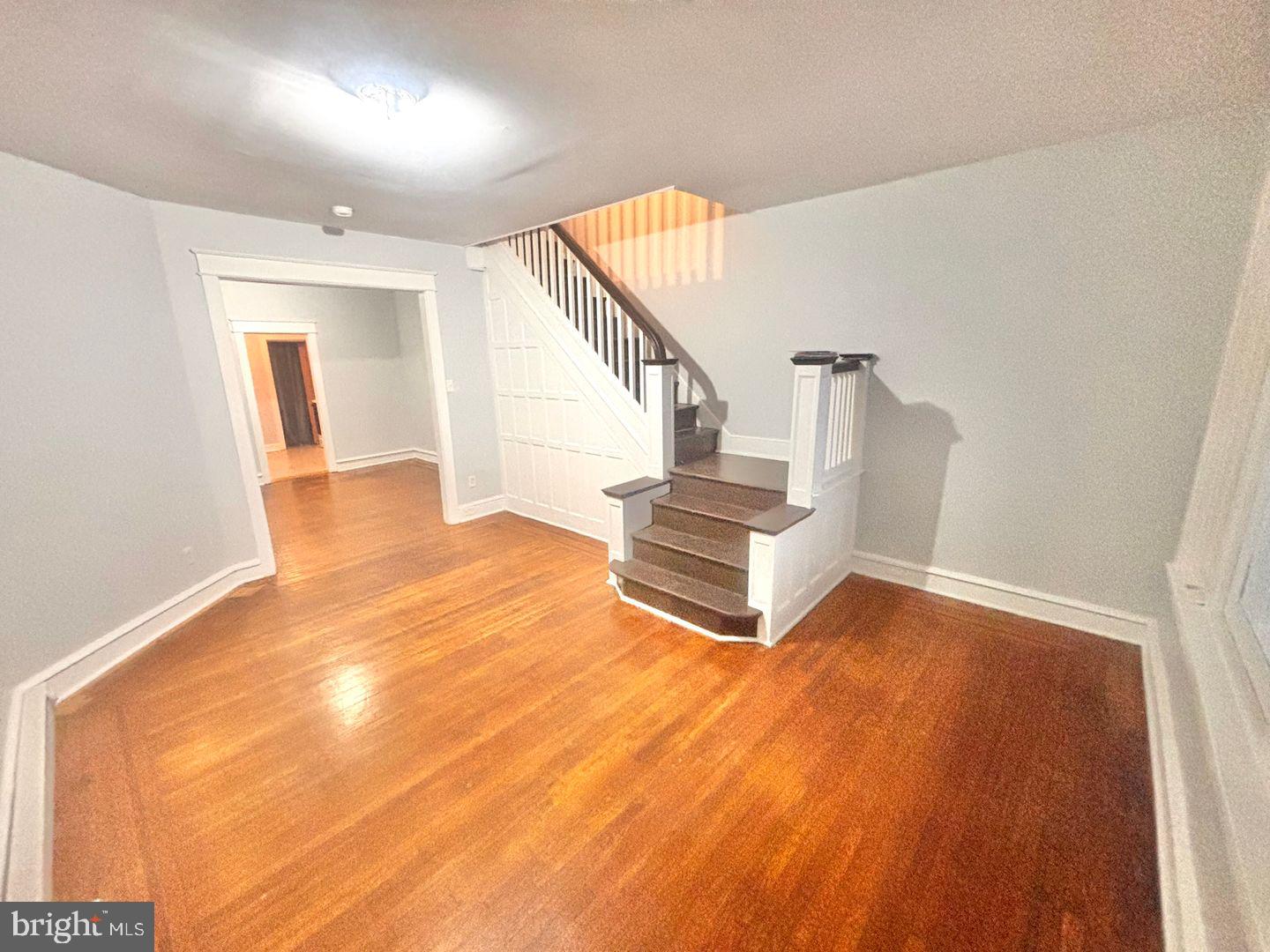 1736 North 59th Street Philadelphia, PA 19151 - Photo 18 of 19 a view of an empty room with wooden floor and stairs