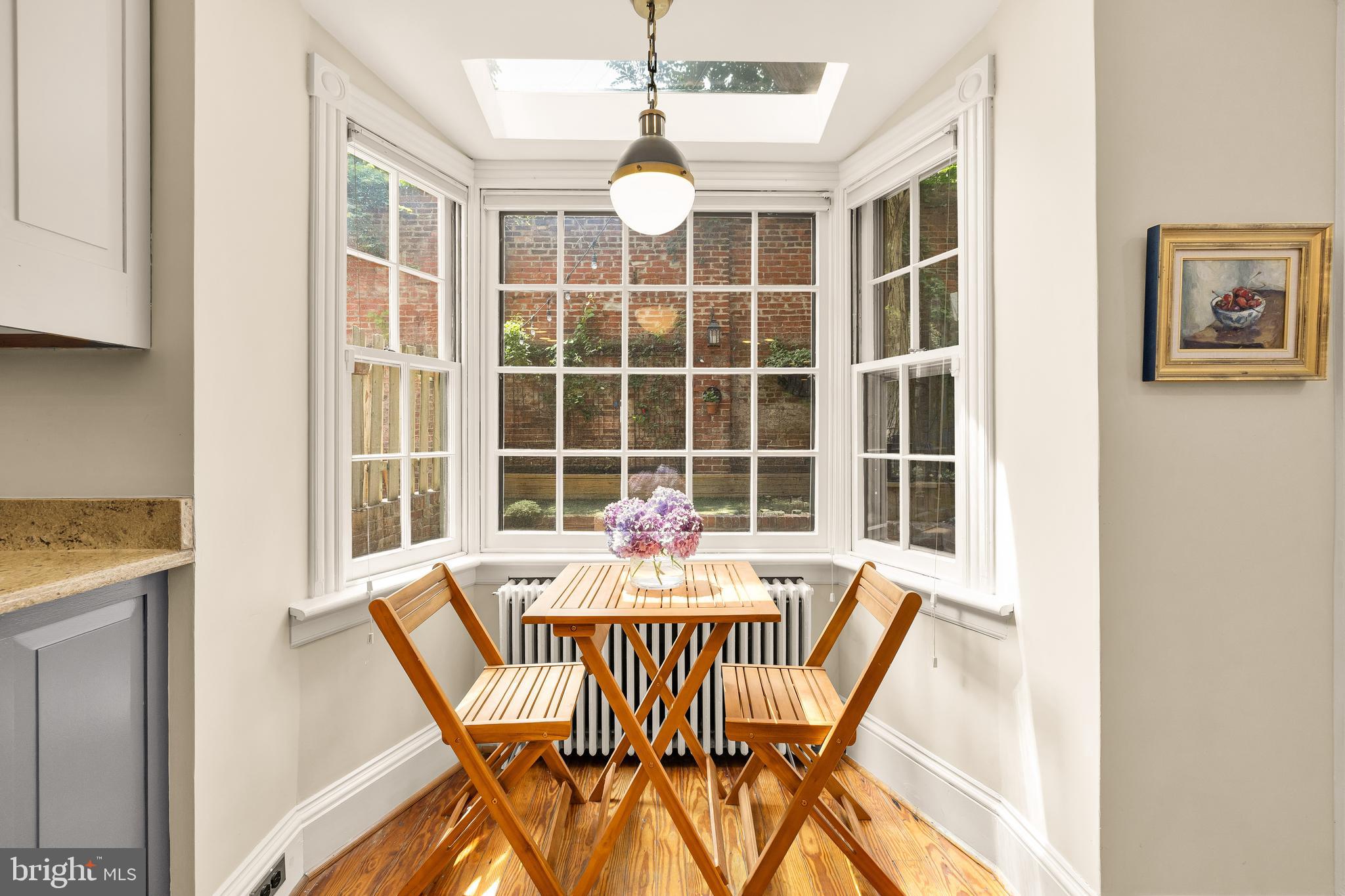 107 5th Street Southeast Washington, DC 20003 - Photo 12 of 26 a dining room with furniture a rug and wooden floor