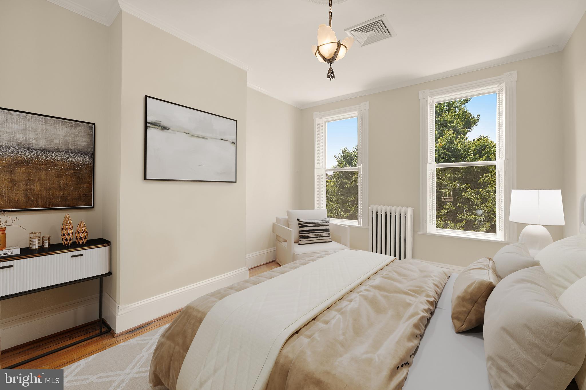 107 5th Street Southeast Washington, DC 20003 - Photo 21 of 26 a bedroom with a bed and a flat screen tv