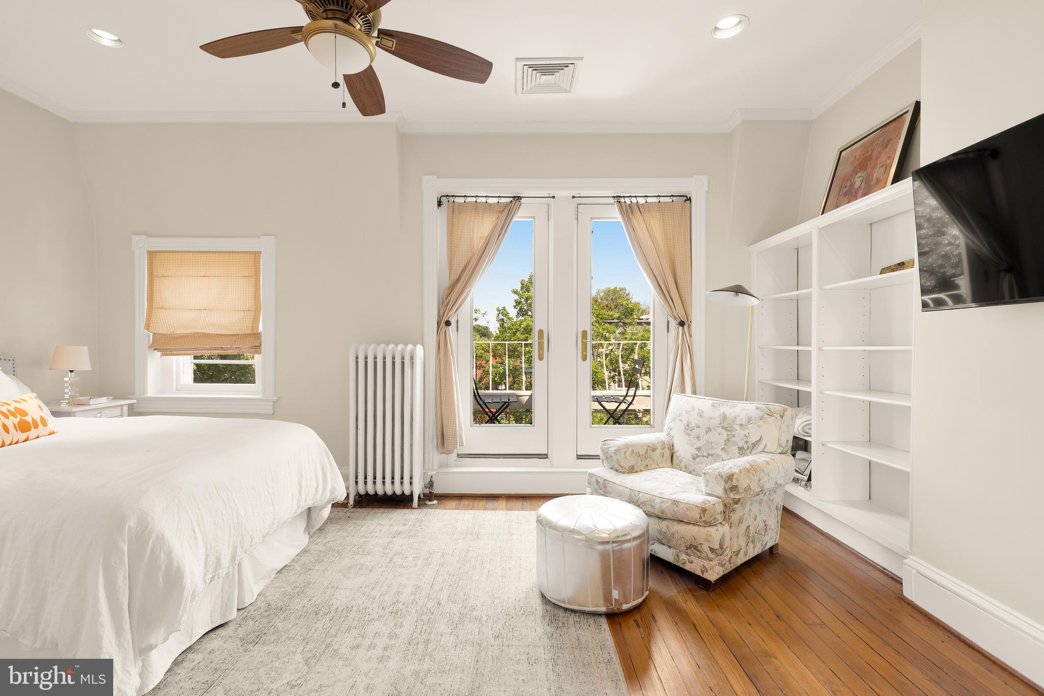 107 5th Street Southeast Washington, DC 20003 - Photo 22 of 26 a spacious bedroom with a bed and large windows