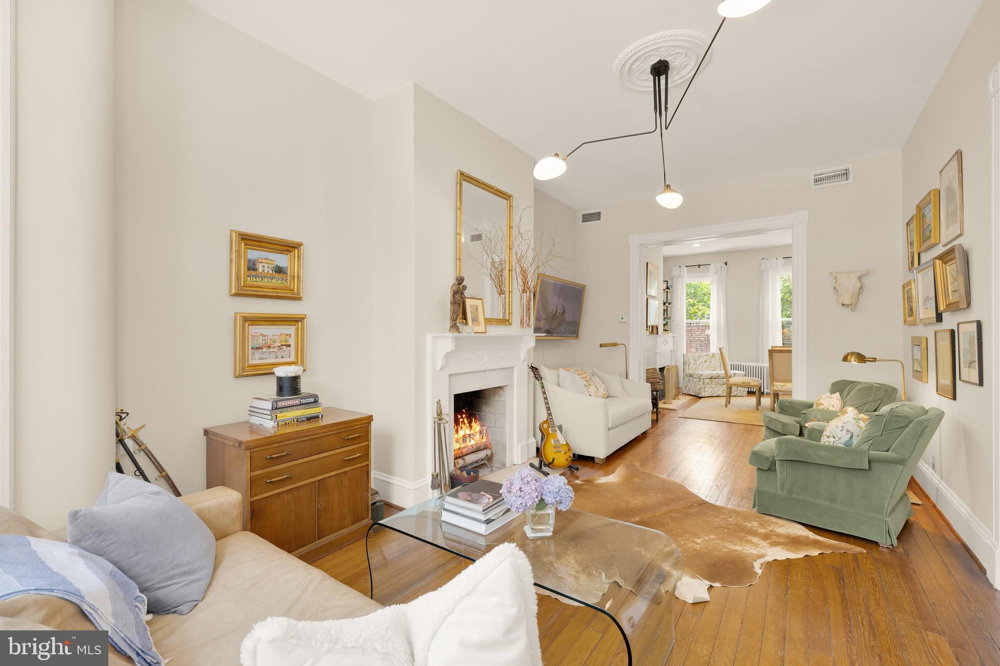 107 5th Street Southeast Washington, DC 20003 - Photo 5 of 26 a living room with fireplace furniture and a chandelier