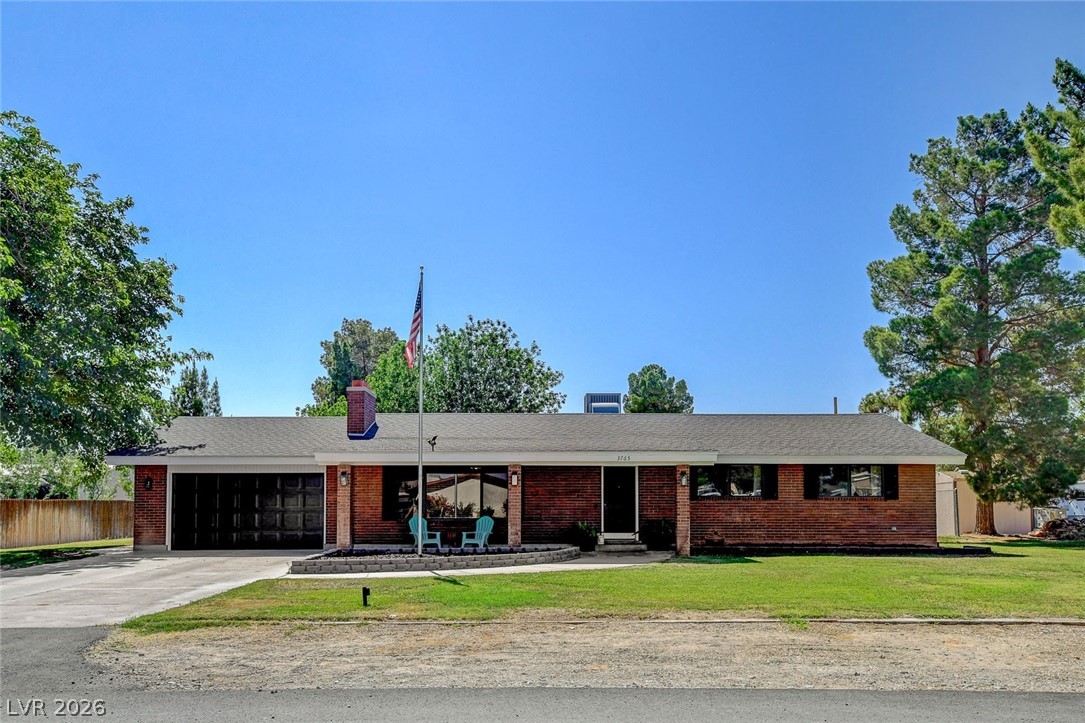 3765 Berkeley Street Logandale, NV 89021 - Photo 10 of 87 This classic brick ranch home features an attached garage and a neatly maintained front yard.