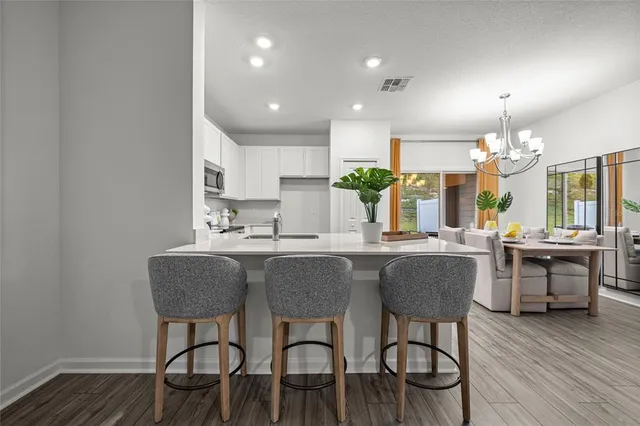 a kitchen with cabinets table and chairs