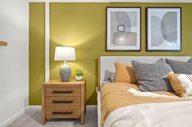 a bedroom with a bed and wall painting