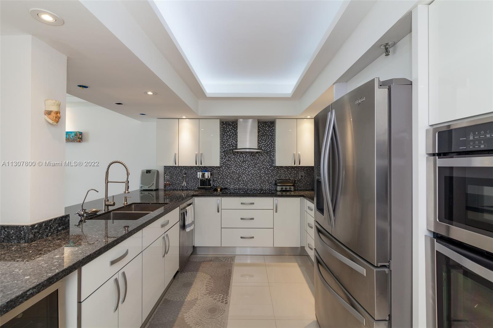 520 Brickell Key Drive, Unit A1603 Miami, FL 33131 - Photo 11 of 27 a kitchen with stainless steel appliances granite countertop a refrigerator and a sink
