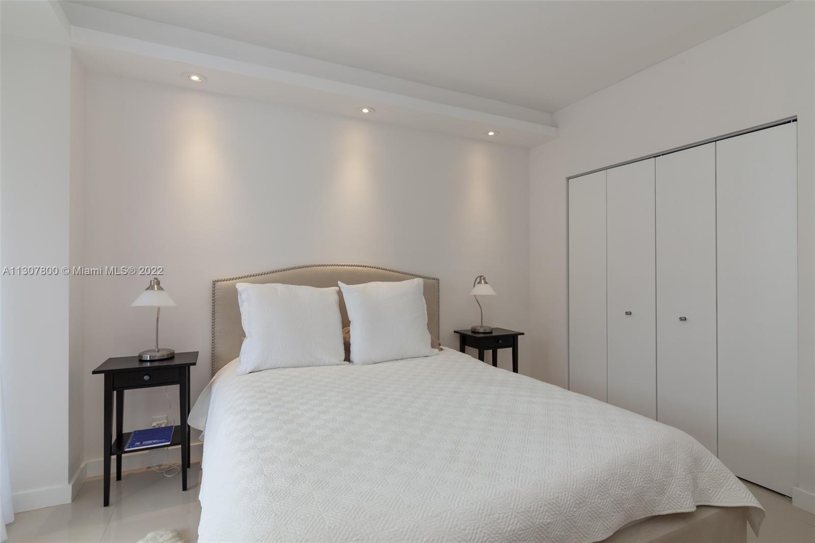 520 Brickell Key Drive, Unit A1603 Miami, FL 33131 - Photo 21 of 27 a bedroom with a bed and a table