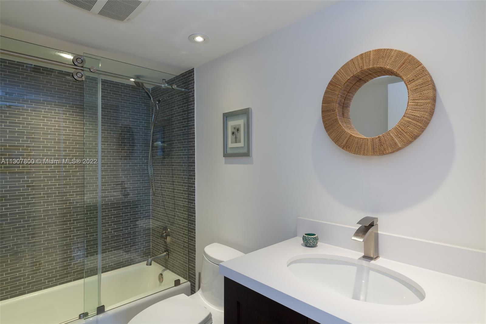 520 Brickell Key Drive, Unit A1603 Miami, FL 33131 - Photo 22 of 27 a bathroom with a sink a toilet and shower