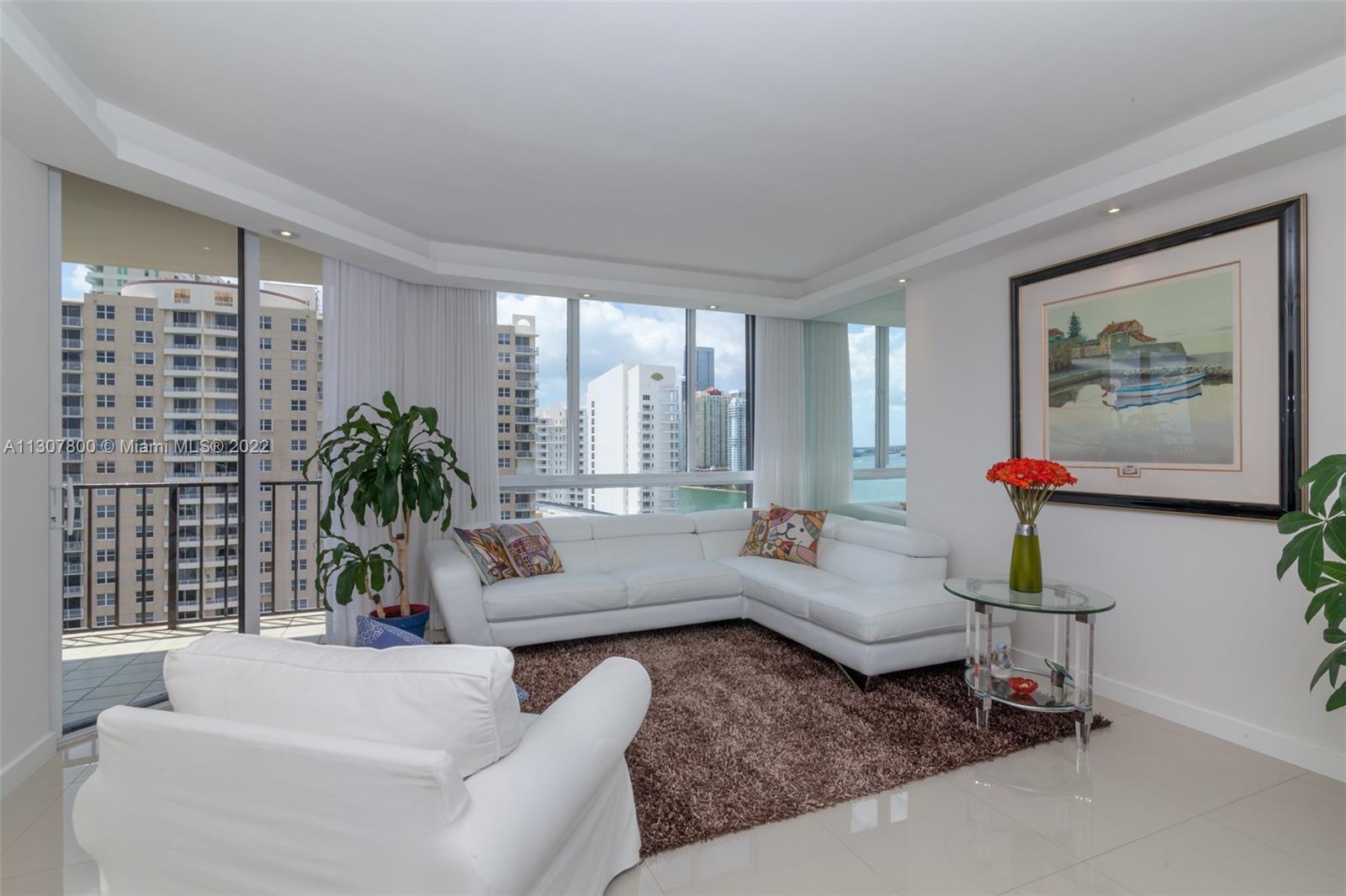 520 Brickell Key Drive, Unit A1603 Miami, FL 33131 - Photo 3 of 27 a living room with furniture and a large window