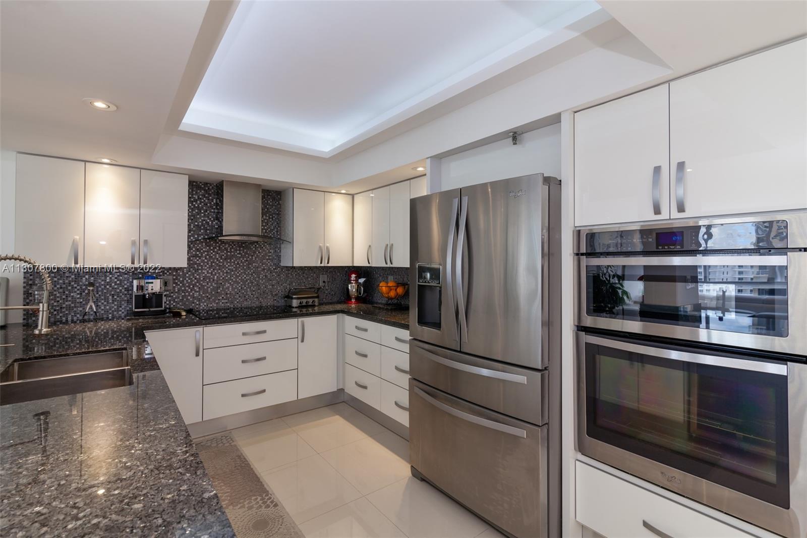 520 Brickell Key Drive, Unit A1603 Miami, FL 33131 - Photo 10 of 27 a kitchen with granite countertop stainless steel appliances and refrigerator