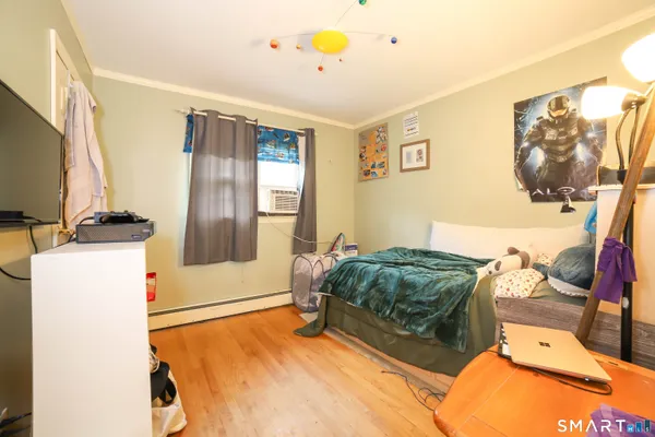 a bedroom with a bed and a flat screen tv