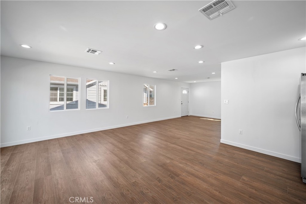 7445 Balcom Avenue Reseda, CA 91335 - Photo 11 of 73 an empty room with wooden floor and windows