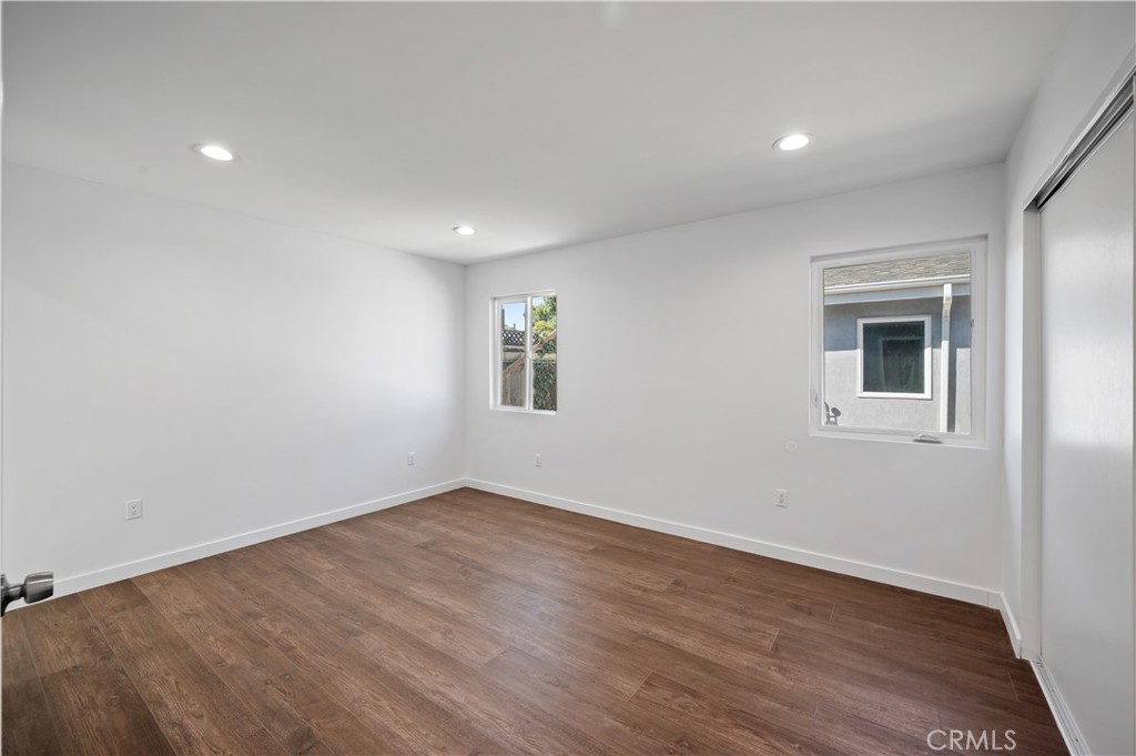 7445 Balcom Avenue Reseda, CA 91335 - Photo 14 of 73 a view of an empty room with wooden floor and a window