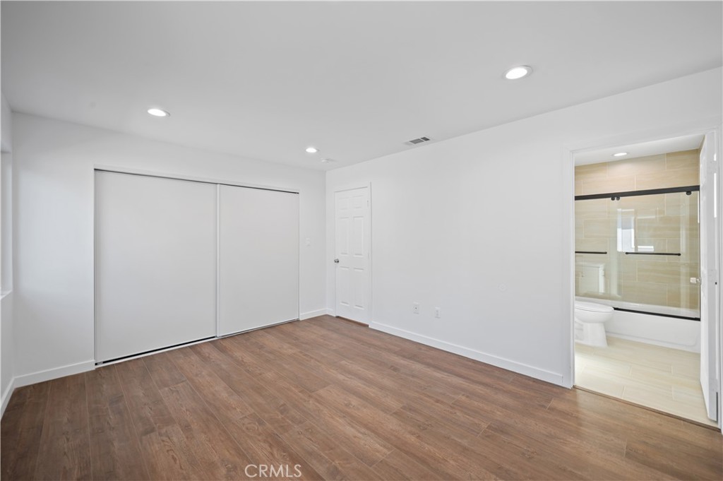 7445 Balcom Avenue Reseda, CA 91335 - Photo 15 of 73 a view of an empty room with wooden floor and a window