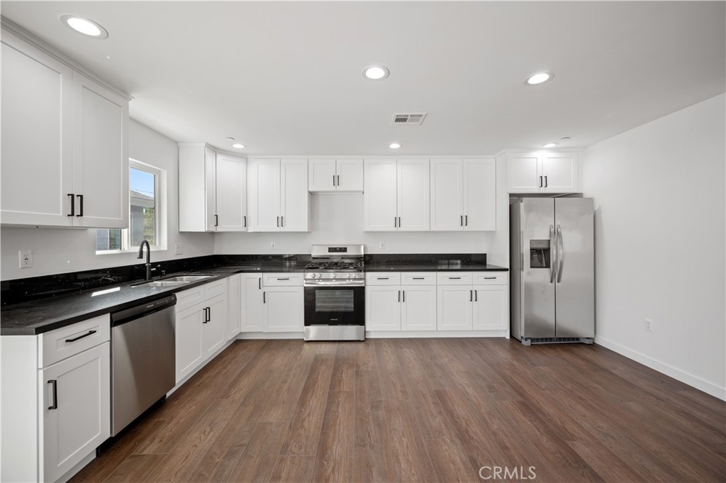 7445 Balcom Avenue Reseda, CA 91335 - Photo 29 of 73 a large kitchen with granite countertop a large counter top a sink stainless steel appliances and cabinets