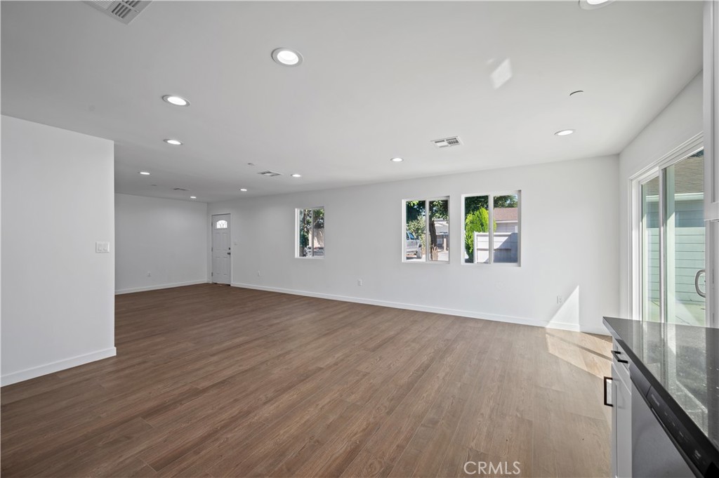 7445 Balcom Avenue Reseda, CA 91335 - Photo 31 of 73 an empty room with wooden floor and windows