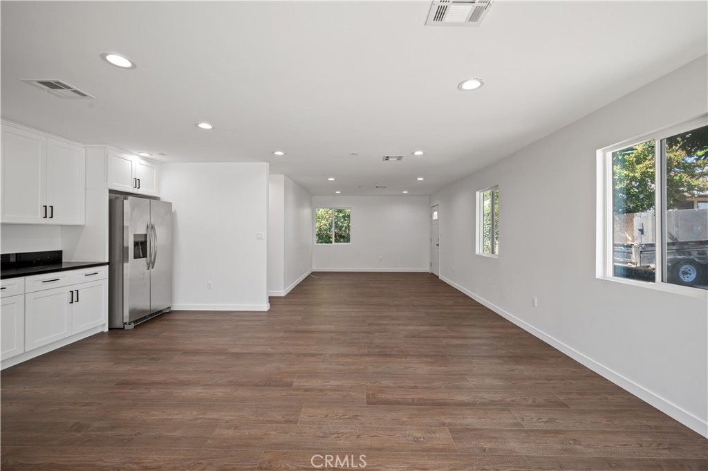 7445 Balcom Avenue Reseda, CA 91335 - Photo 32 of 73 a view of an empty room with window and wooden floor