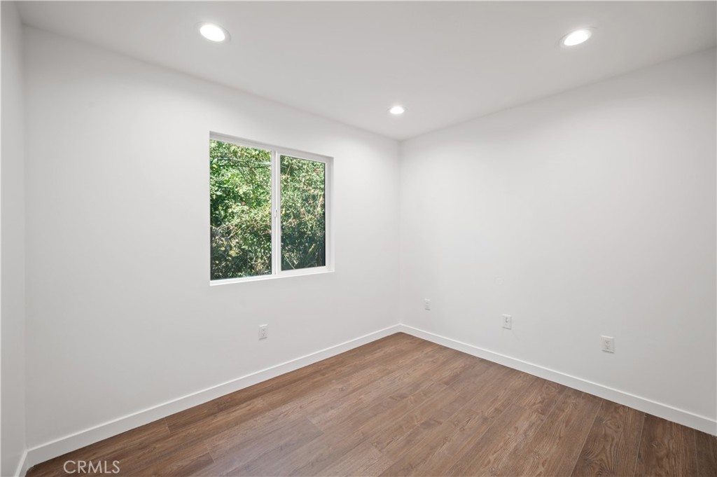 7445 Balcom Avenue Reseda, CA 91335 - Photo 33 of 73 an empty room with wooden floor and windows
