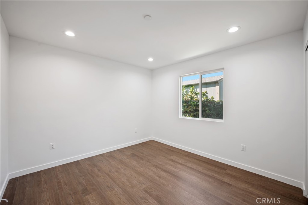 7445 Balcom Avenue Reseda, CA 91335 - Photo 35 of 73 an empty room with wooden floor and window