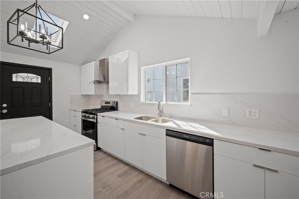 7445 Balcom Avenue Reseda, CA 91335 - Photo 37 of 73 a kitchen that has a sink a stove and cabinets