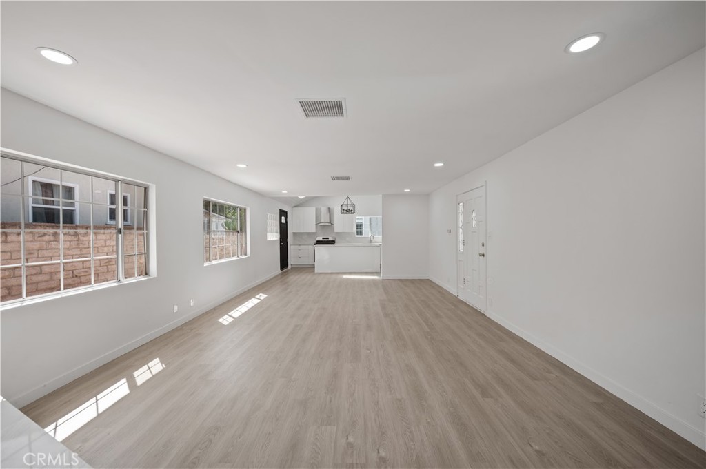 7445 Balcom Avenue Reseda, CA 91335 - Photo 43 of 73 a view of empty room with wooden floor and windows