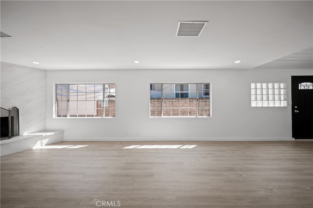 7445 Balcom Avenue Reseda, CA 91335 - Photo 45 of 73 a view of an empty room with wooden floor and a window