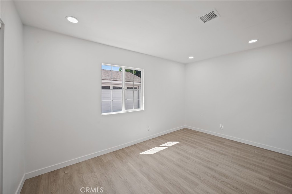 7445 Balcom Avenue Reseda, CA 91335 - Photo 52 of 73 an empty room with wooden floor and windows