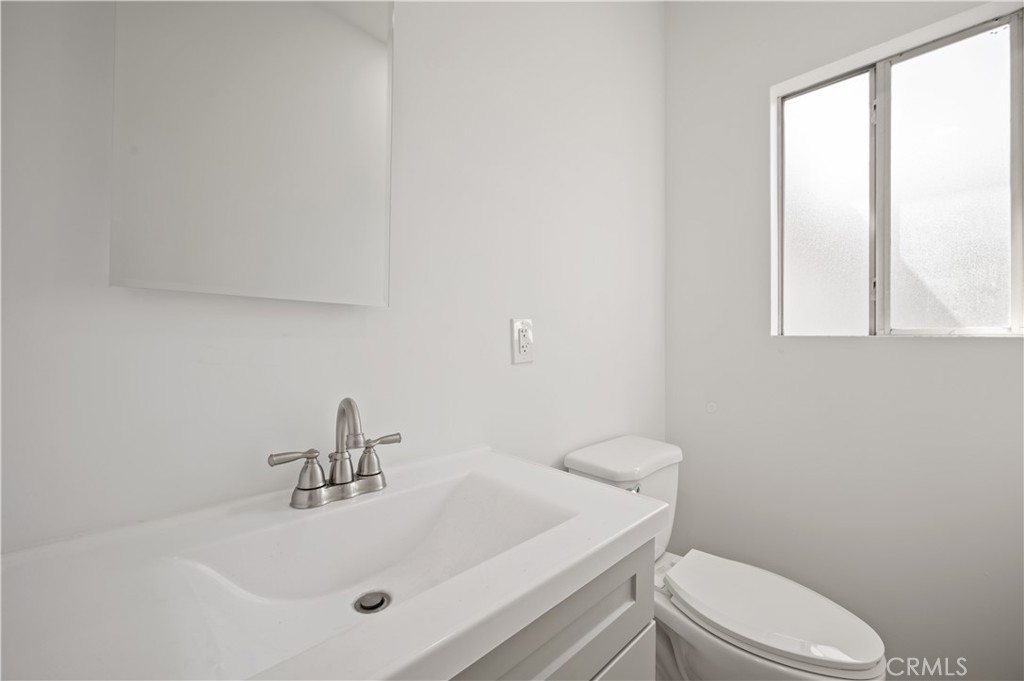 7445 Balcom Avenue Reseda, CA 91335 - Photo 55 of 73 a bathroom with a sink a toilet and window