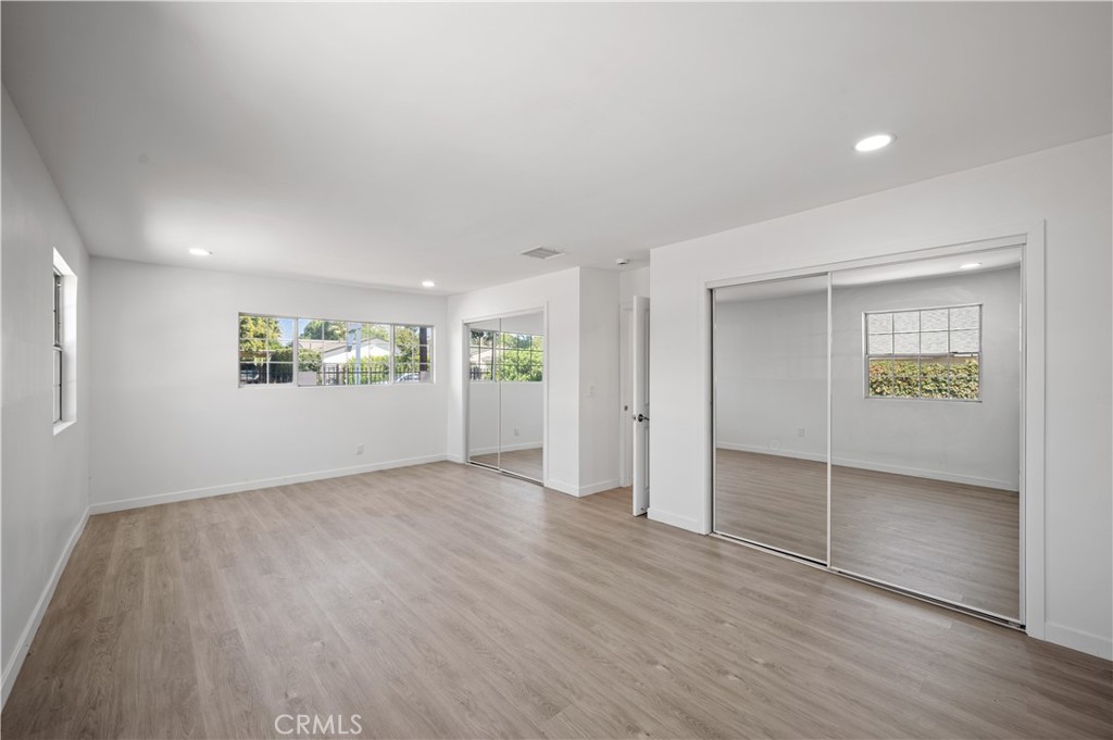 7445 Balcom Avenue Reseda, CA 91335 - Photo 60 of 73 an empty room with wooden floor and windows