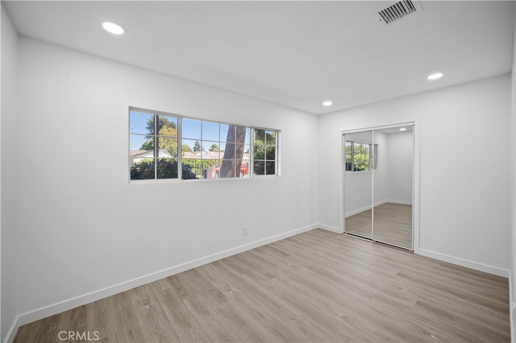 7445 Balcom Avenue Reseda, CA 91335 - Photo 62 of 73 an empty room with wooden floor and windows