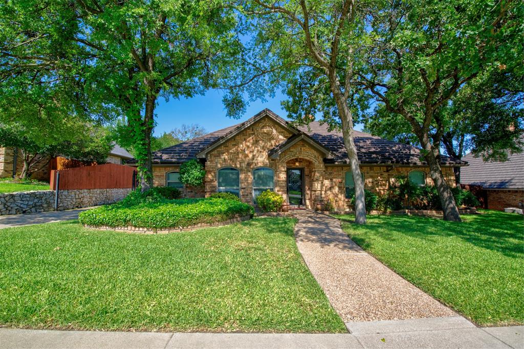 a front view of house with yard and green space