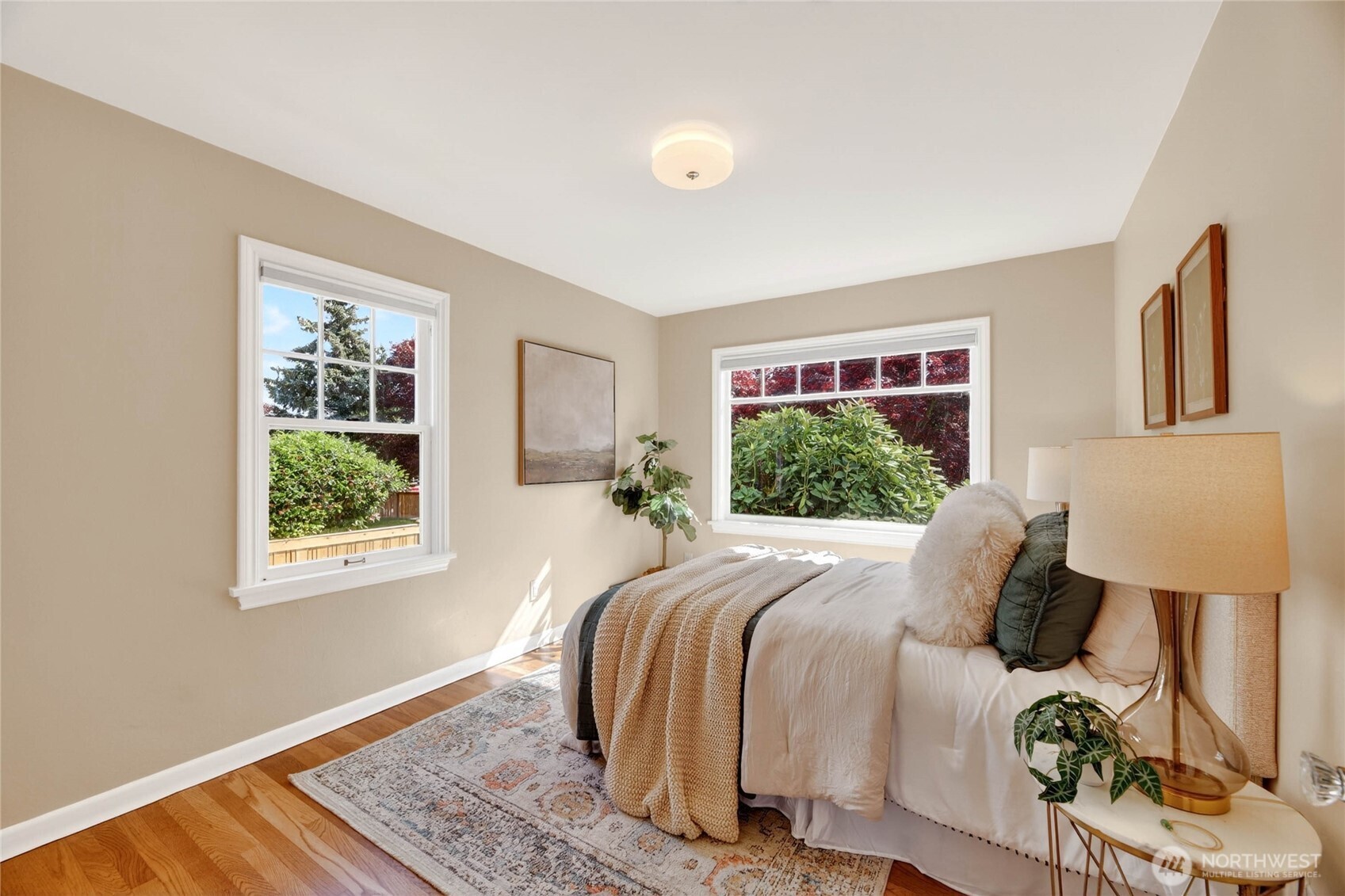 3245 45th Avenue Southwest Seattle, WA 98116 - Photo 13 of 31 a bedroom with a bed a window and a lamp