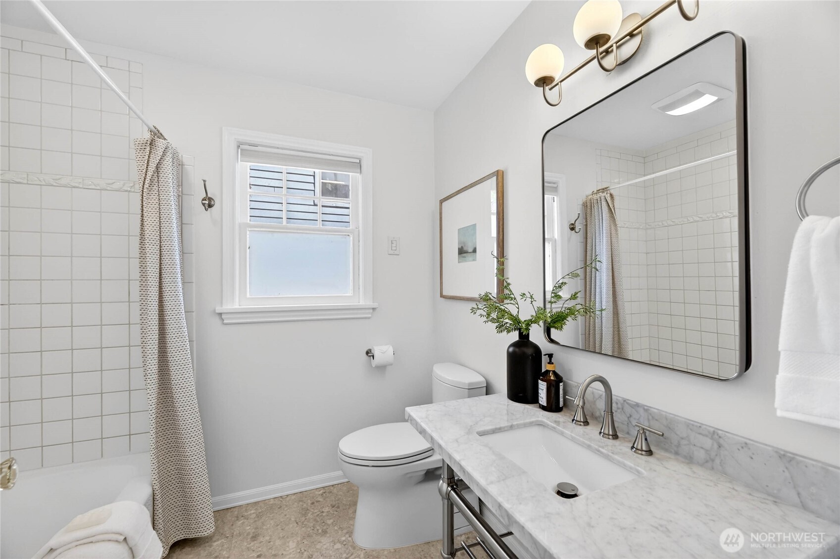 3245 45th Avenue Southwest Seattle, WA 98116 - Photo 15 of 31 a bathroom with a granite countertop toilet sink and mirror