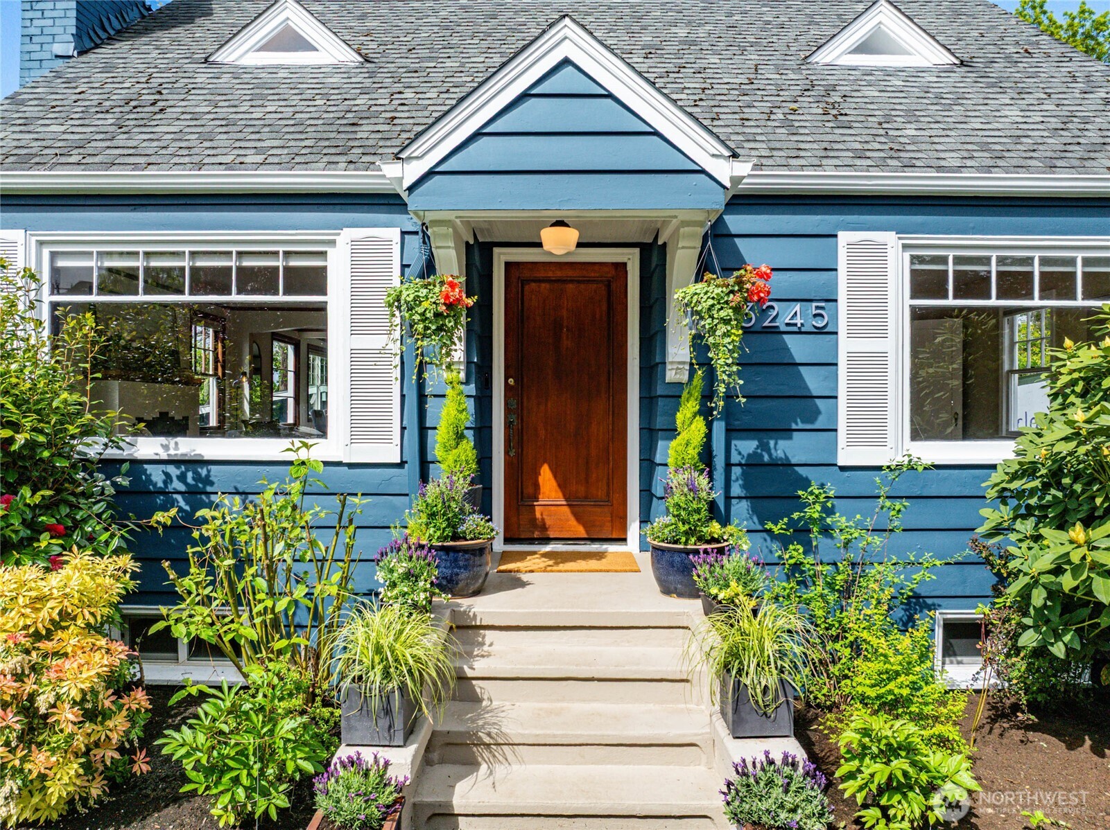 3245 45th Avenue Southwest Seattle, WA 98116 - Photo 3 of 31 a front view of a house with potted plants