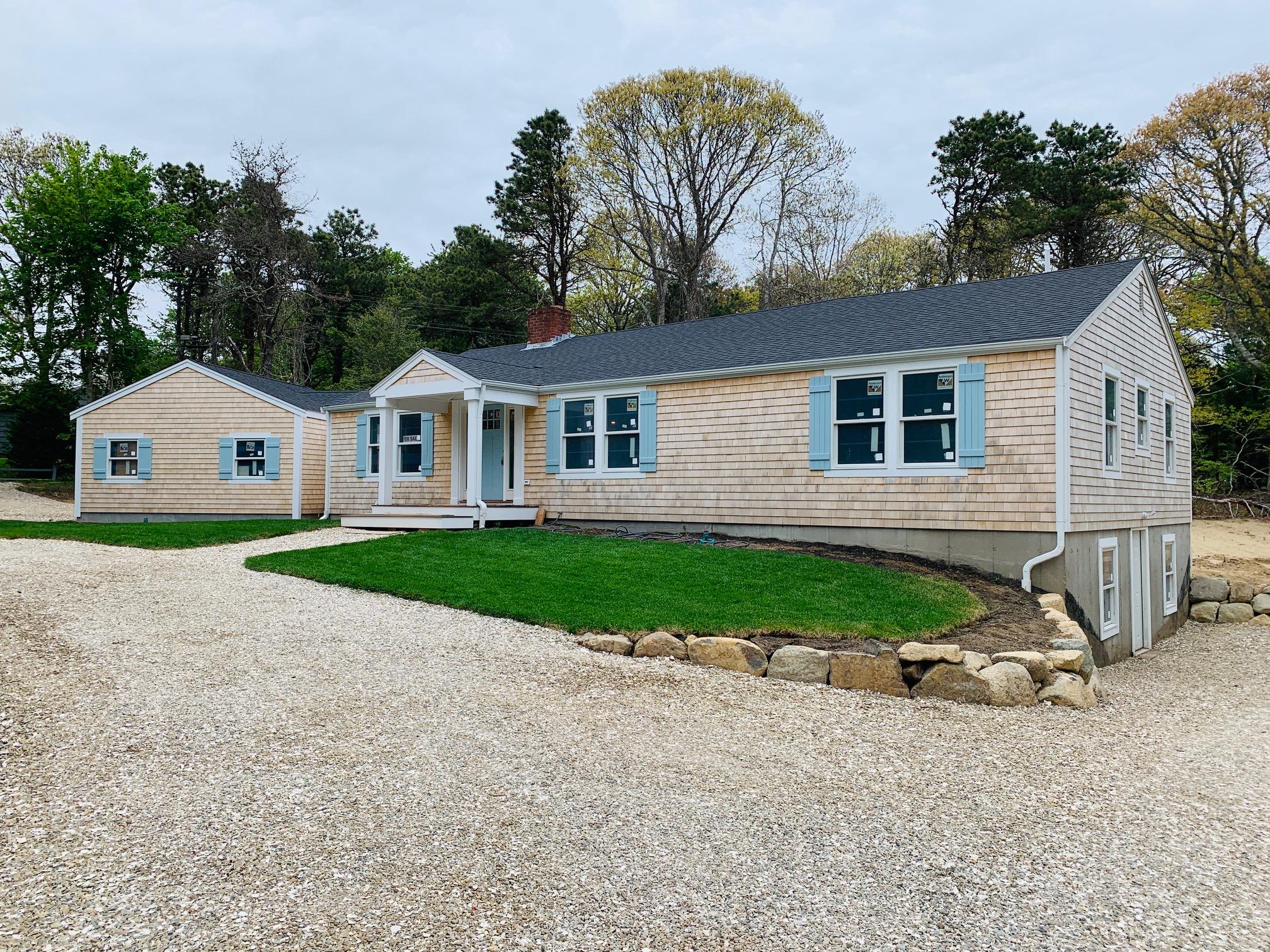 152 Barley Neck Road Orleans, MA 02653 - Photo 2 of 16 a view of a white house with a yard and potted plants
