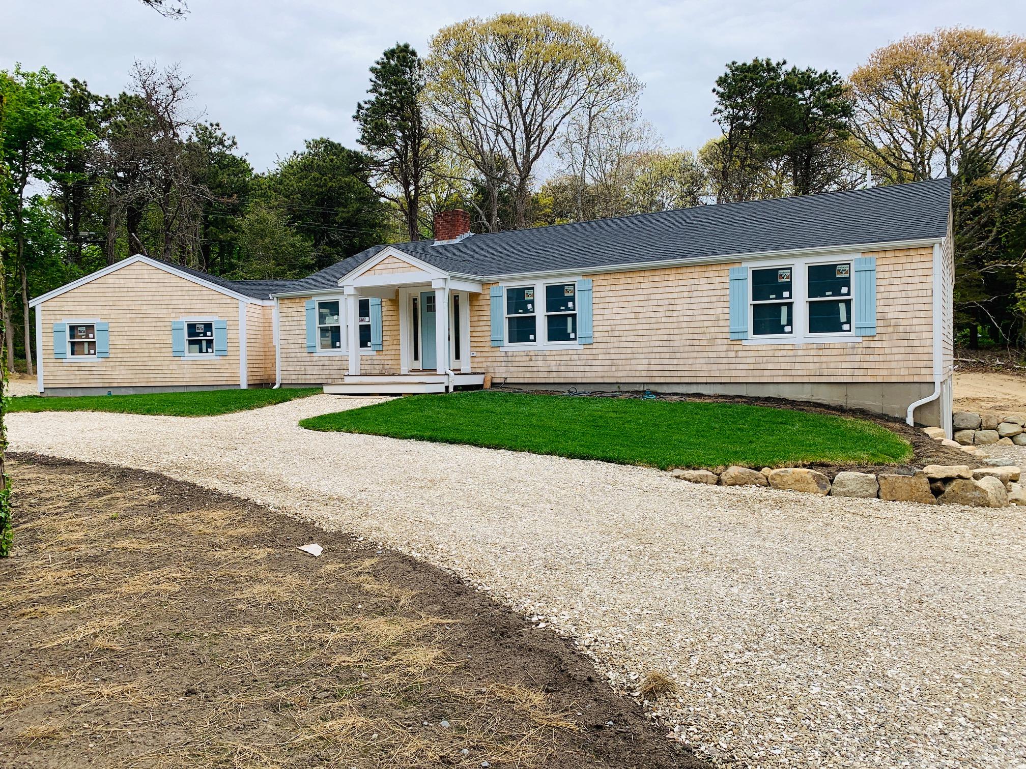 152 Barley Neck Road Orleans, MA 02653 - Photo 3 of 16 a front view of a house with a yard and garage