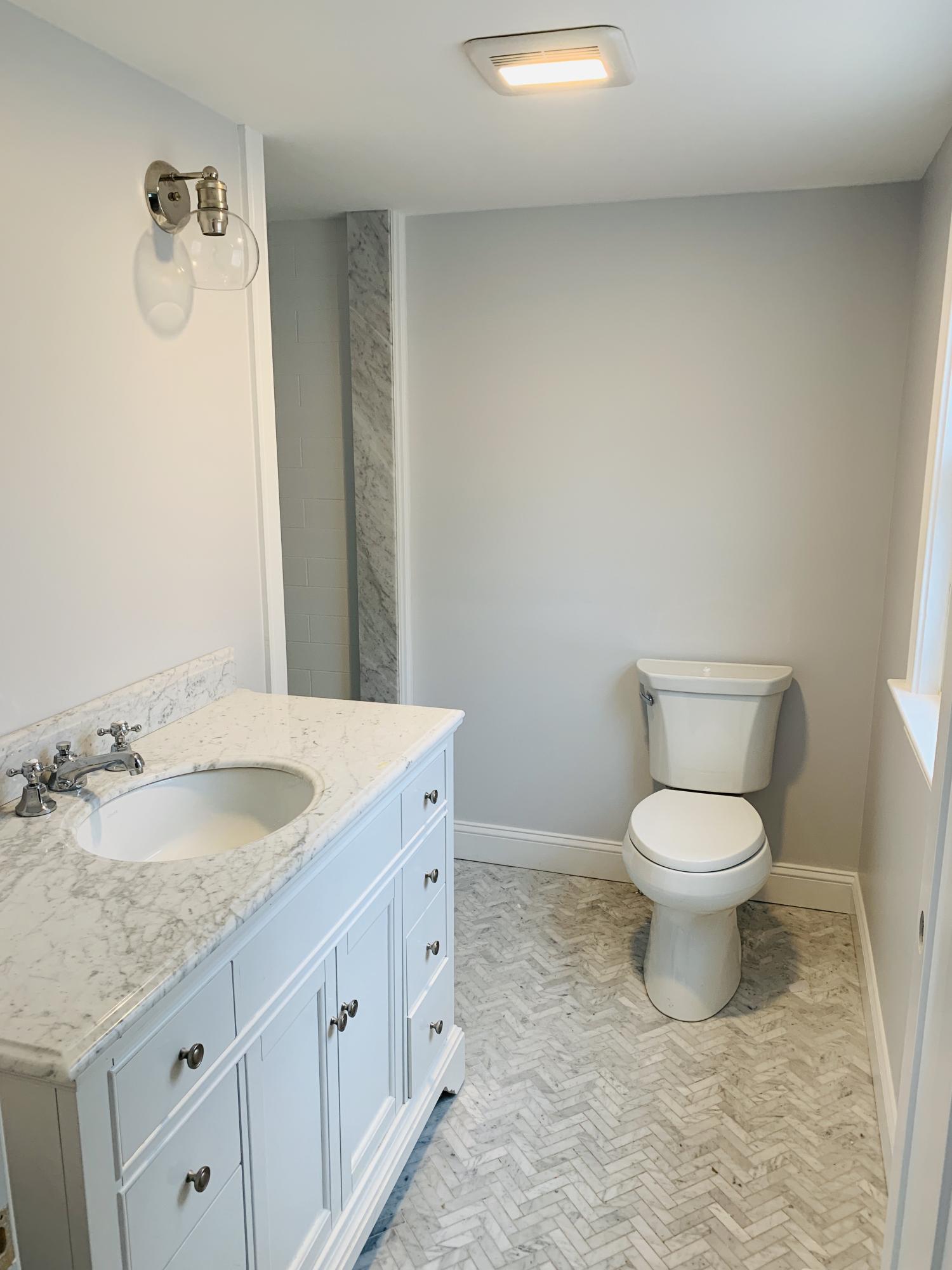 152 Barley Neck Road Orleans, MA 02653 - Photo 6 of 16 a bathroom with a granite countertop toilet and a sink