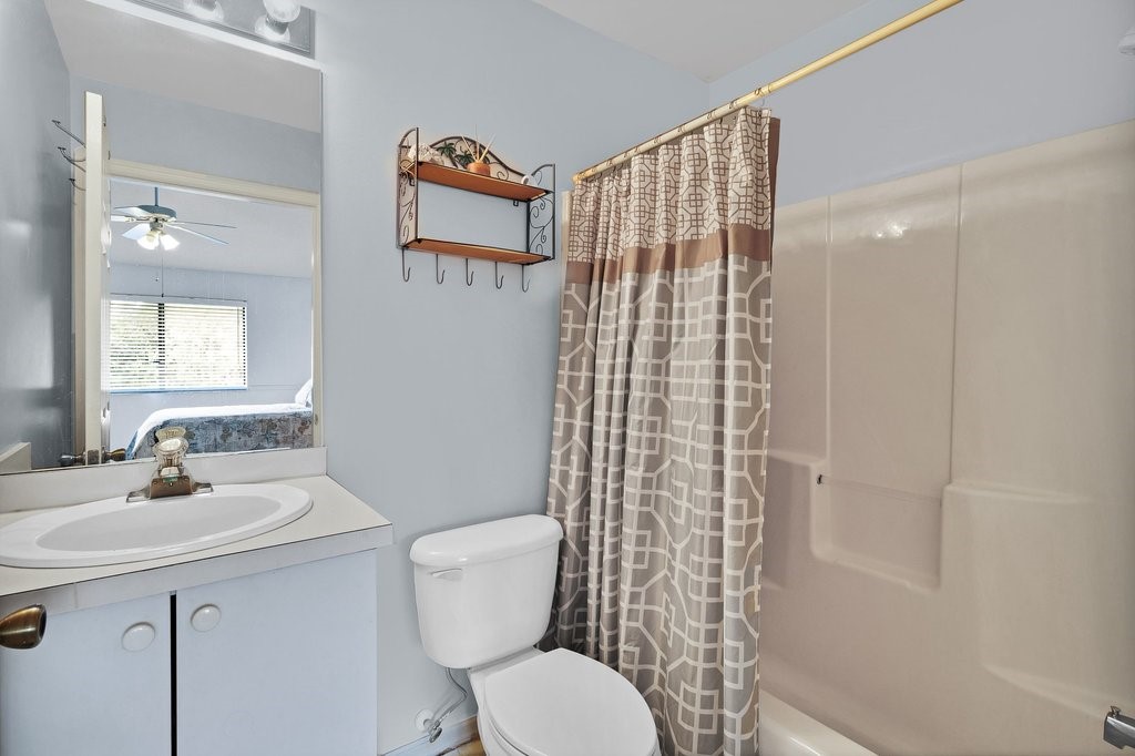 9637 Riverside Drive, Unit 3 Sebastian, FL 32958 - Photo 16 of 36 a bathroom with a sink toilet and shower