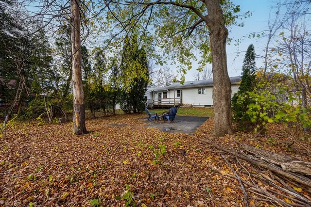a view of a lake with a bench and trees around